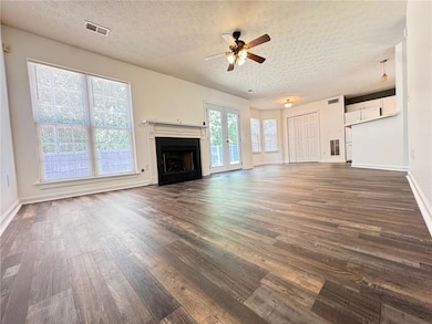 Unfurnished living room with a ceiling fan, a text