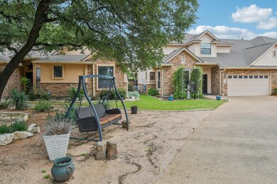View of front of home with stone siding, a garage