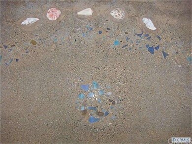 Sea-colored pebbles and shells in bench.