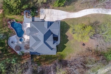 Gorgeous custom home surrounded by mature trees.