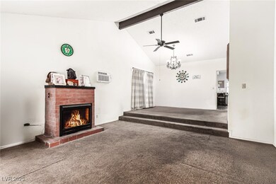 Living room featuring beam ceiling, carpet floors,