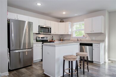 Kitchen with sink, a center island, dark hardwood