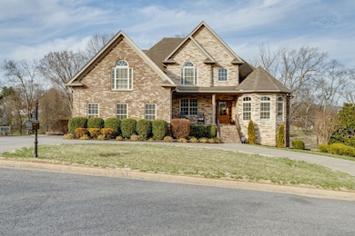 Stunning brick and stone exterior with covered front porch