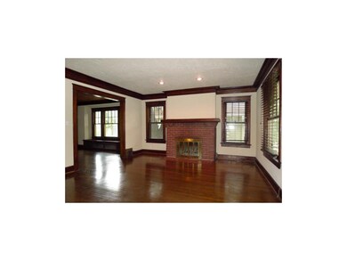 Original, detailed trim work and brick fireplace