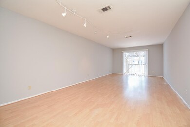 Spacious and well-lit living area with elegant har