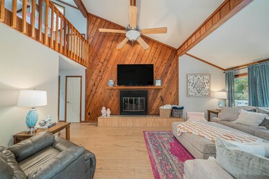Living room with high vaulted ceiling, wooden wall