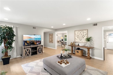 View of Living Room looking into Great Room. Porcelain Tile Floors, Recessed Lighting, New Interior & Exterior Paint