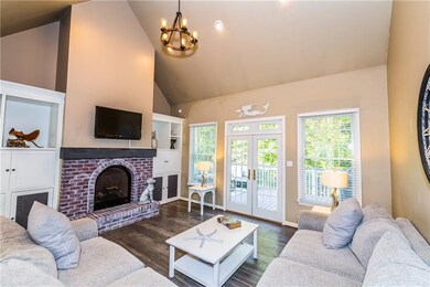 Bright living room with vaulted ceiling.