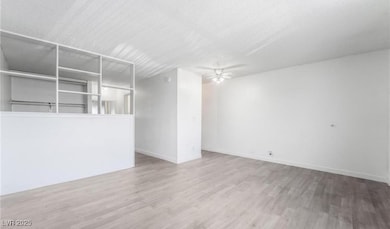 Empty room with baseboards, wood finished floors,