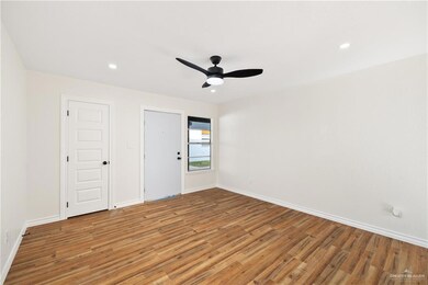 Empty room featuring hardwood / wood-style flooring and ceiling fan