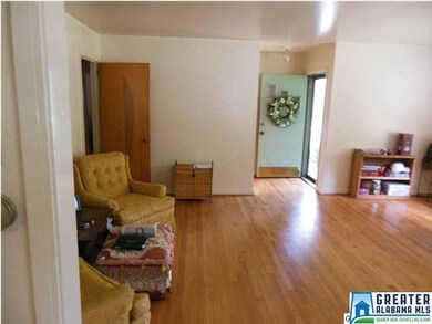 Living room has gleaming hardwood.
