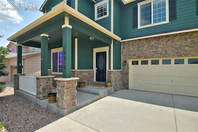 Property entrance with stone siding, a porch.