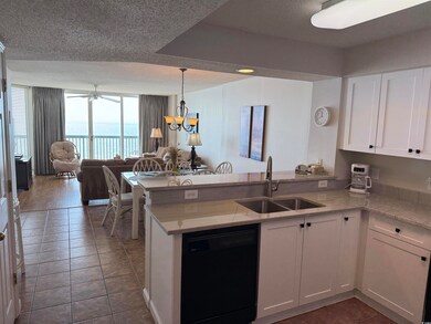 Kitchen featuring white cabinets, a peninsula, bla