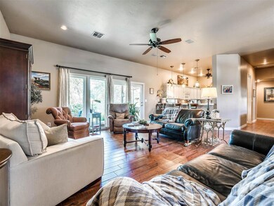 Living room featuring ceiling fan and hardwood / w