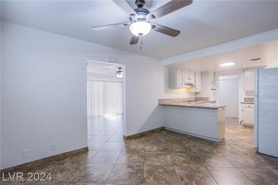 Kitchen featuring dark tile patterned flooring, wh