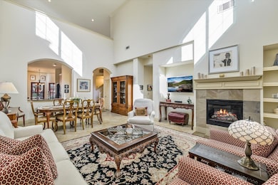 Living area featuring arched walkways, a high cei