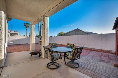 Fenced backyard with outdoor dining area and a pat