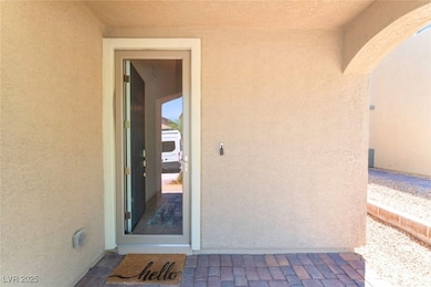 Property entrance featuring stucco siding