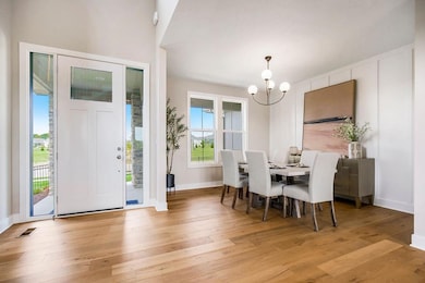 Dining area with a chandelier and light wood-style floors