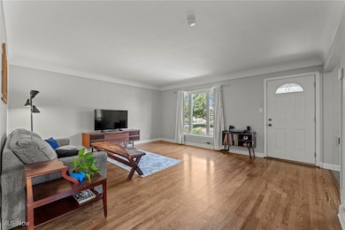 Living room with light wood finished floors and baseboards