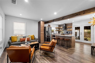 Living room featuring visible vents, recessed ligh