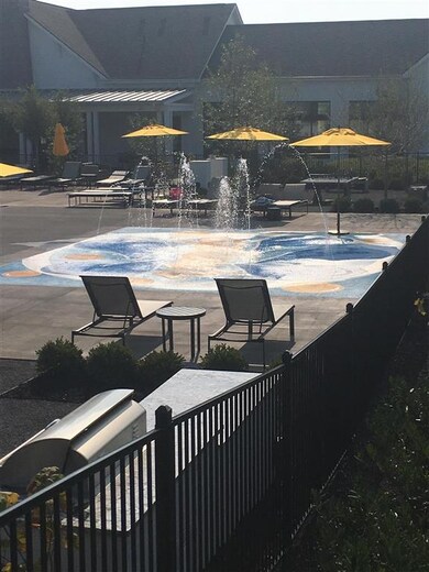 The splashpad is so cool!   In the forefront of this photo, you can see 1 of the 2 gas grills in this area for the homeowner's to make the most of their day at the pool. Or....go inside and get a fresh sandwich or salad from the Cafe'.