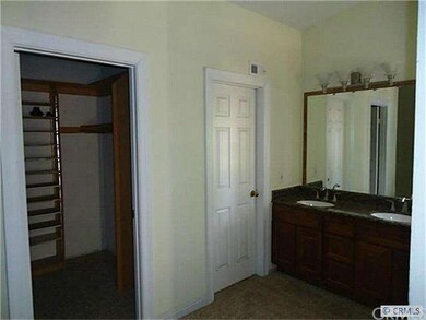 master bedroom: walking closet;  door leading to shower and toilet; separate double sinks in dressing area