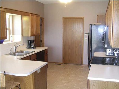 Kitchen w/ Pantry, Breakfast Bar + Tile Flooring