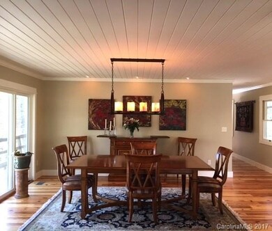 Dining area with wood paneled ceiling.