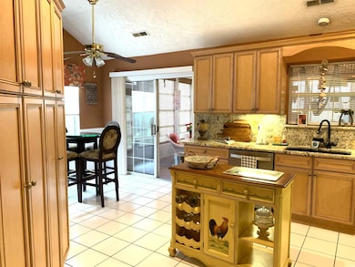 Large kitchen with a breakfast nook and entry into the 4 Seasons Room.