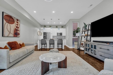 Living area with dark wood-style floors and recessed lighting
