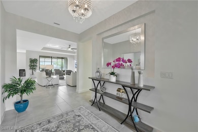 Hallway with a tray ceiling, tile patterned floors