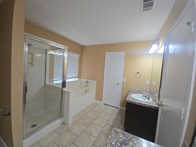 Bathroom with vanity, a bath, tile patterned flooring, and a stall shower