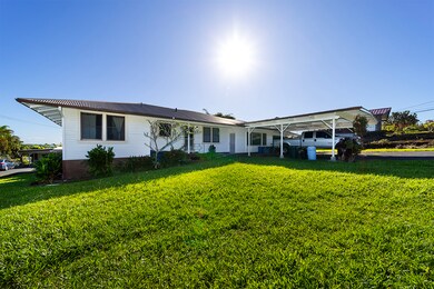 The front house is 2,140 sq ft with two units. The left side has 3 beds, 2 baths. The right side has a 1-bed, 1-bath unit with kitchen and living room, created by enclosing the carport. A shared door connects the units. Each side has a carport.