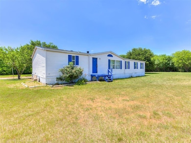 Manufactured / mobile home featuring a front lawn and entry steps