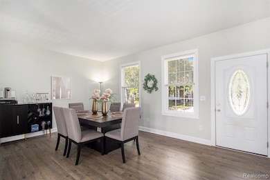Dining space with dark wood-style flooring