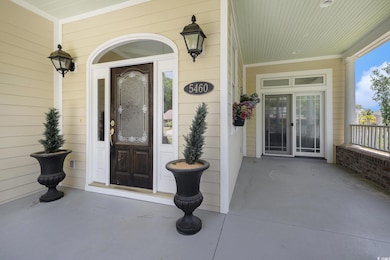 View of exterior entry with covered porch