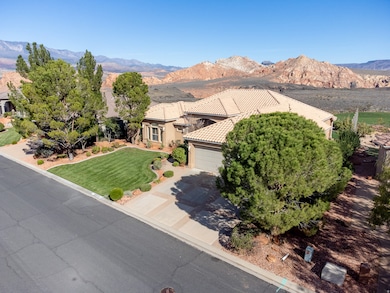 View of front facade with a mountain view, driveway, an attached garage, and a front yard