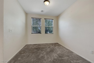 Spare room with carpet and baseboards