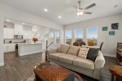 Living room with sink, dark hardwood / wood-style 