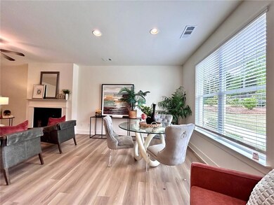 Dining area with light wood-style floors, baseboards, a fireplace, ceiling fan, and recessed lighting