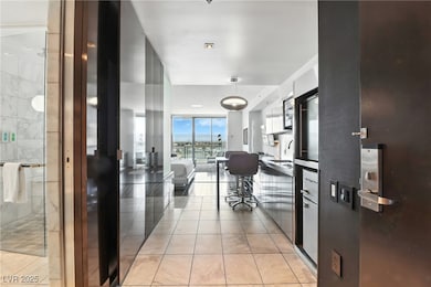 Hall featuring light tile patterned floors and floor to ceiling windows
