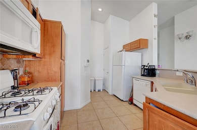 Kitchen featuring light countertops, decorative ba
