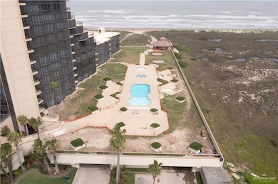 Aerial overview of property's location featuring a pool area and a nearby body of water