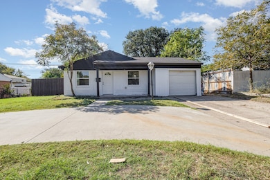 Single story home featuring covered porch, driveway, and a garage