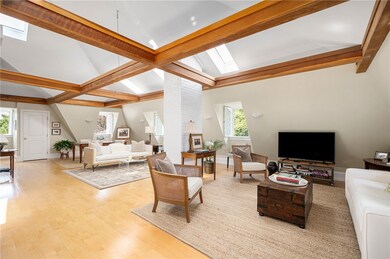 Open living area with wood drop beams to open ceil