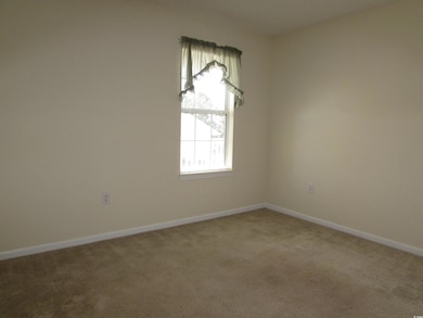 Front left bedroom with a ceiling fan.
