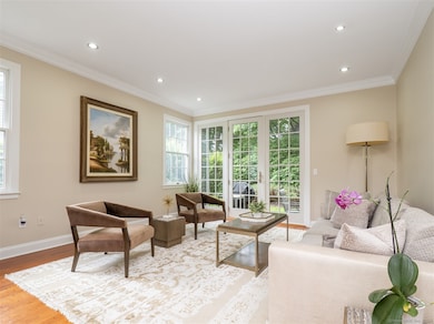 The living room is spacious and bright with access to the private back patio.