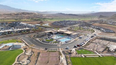 Aerial view of property and surrounding area featuring mountains and nearby suburban area