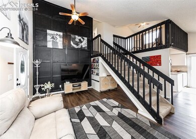 Living room with a textured ceiling, high vaulted 